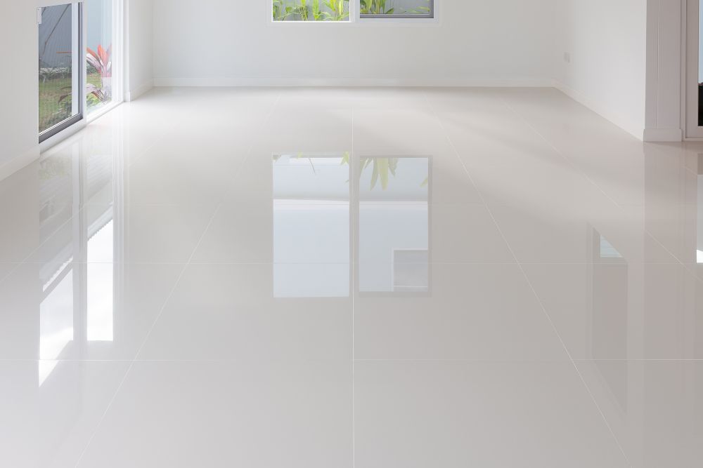 White room with a large window and white tile floor, illustrating tile flooring services offered in Renton, WA.